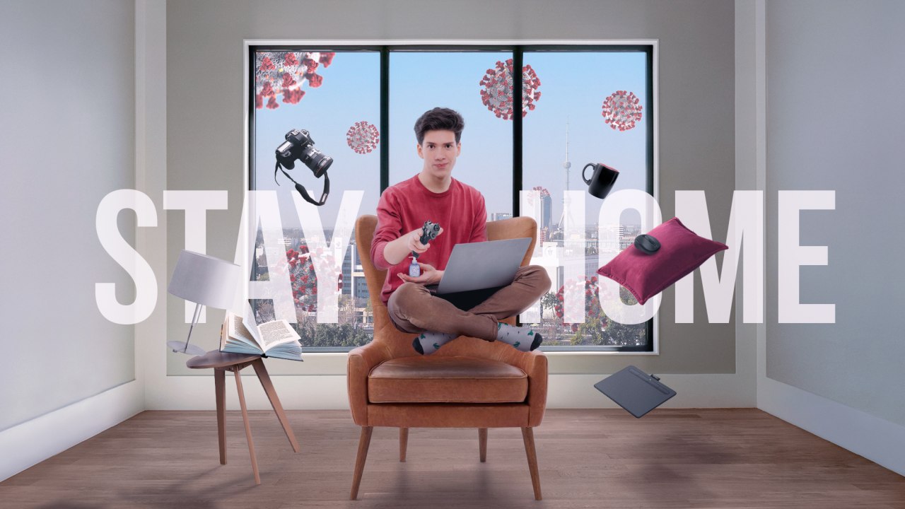 Stay Home campaign composition with a seated laptop user, floating everyday objects and large white typography
